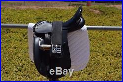 18 Collegiate dressage saddle. Includes leathers, irons, and 28 girth